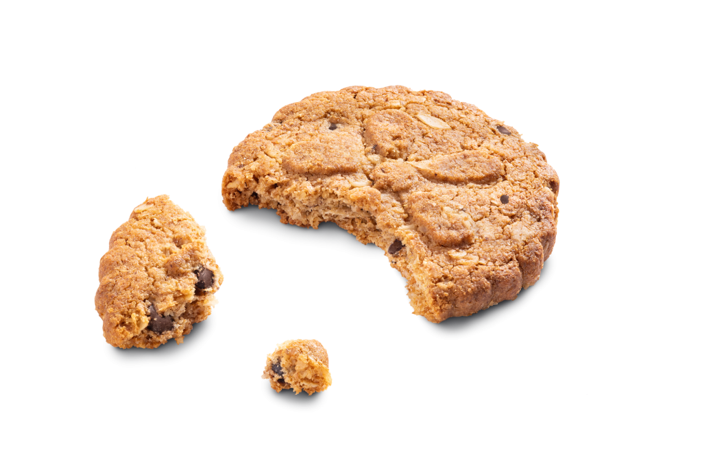 Stacked wholegrain biscuits with crumbs, studio shot